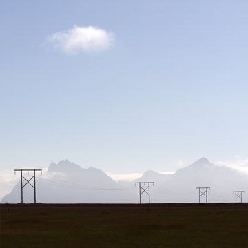 Telegraph poles in front of misty mountians