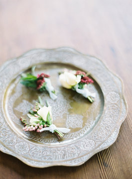 Buttonhole flowers on metal platter