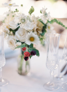 Small flower arrangement and dinner place setting 