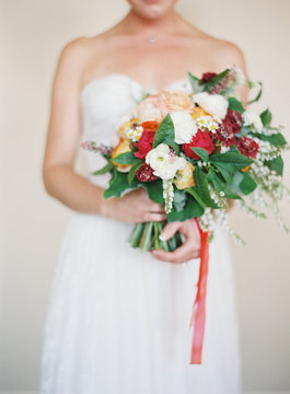 Bridal bouquet with dress in the background 