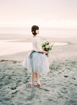 Bride dancing on beach