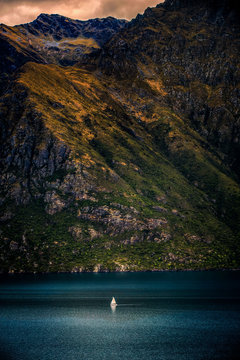 Sailboat on lake by mountains