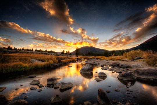 Rocky riverbed and mountain at sunset