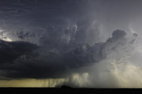 Storm clouds raining above great plains