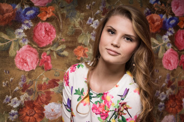 Beautiful sensuality girl on a flower wall background