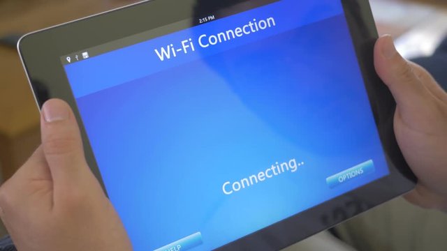 Businessman Using a iPad Tablet to connect to a Wi-Fi wireless connection.