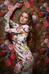 Beautiful sensuality girl on a flower wall background