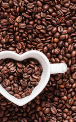 White cup on coffee beans background