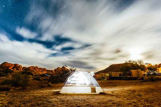 Illuminated tent pitched in joshua park