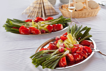Sliced vegetables served on a silver tray