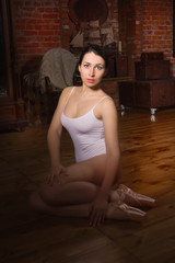 Fototapeta premium Young ballerina in a dark room