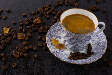 Coffee grains and china cup of coffee