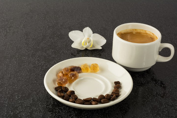Coffee grains, cup of coffee and orchid