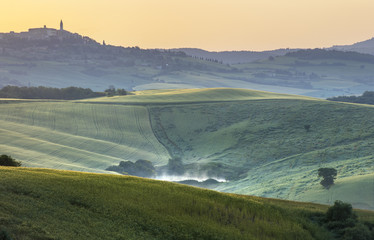 morning landscape with hills and fogged lake in Tuscany in Italy