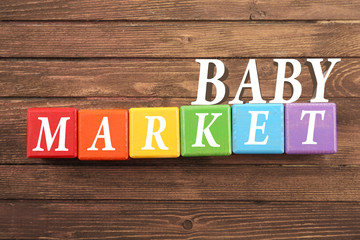Colorful cubes on wooden background. Baby market concept