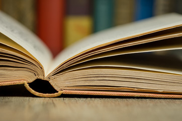 Open book with books in background 