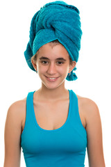 Teen girl with a blue towel wrapped over her wet hair