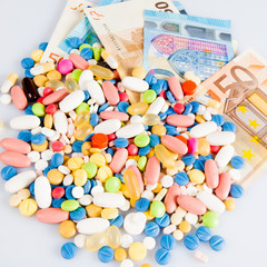pills on money.  medicine tablets on money