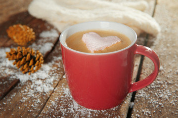 Cup of coffee with marshmallow on wooden table