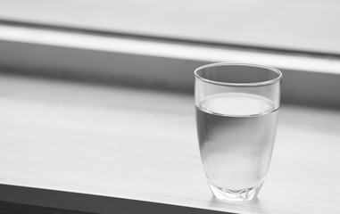 Glass of pure water on windowsill