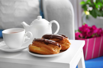 Cup of tea with pastry on the table, closeup