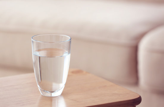 Glass of pure water on wooden table
