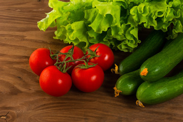 Cucumber and cherry tomato on wooden background