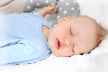 Fototapeta na wymiar Baby sleeping on bed