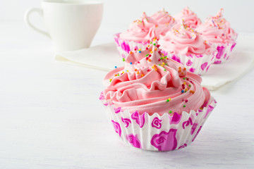 Pink delicious cupcakes  and cup of tea