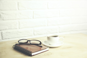 glasses  on notebook and coffee