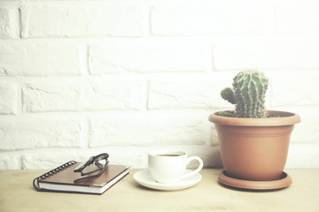 glasses  on notebook and coffee