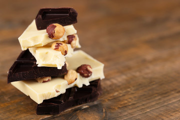 Mix of chocolate with nuts on wooden table