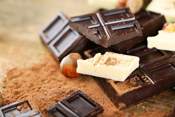 Mix of chocolate with nuts on wooden table