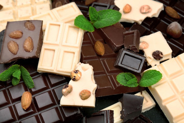 Chocolate pieces with mint leaves, background