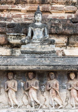 Old stone carvings of the Buddha image and monks