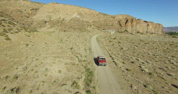 Aerial scene of car traveling on dirt road a dry, rocky, landscape. Monumental scenery. Canyon of Piedra Parada, Chubut, Patagonia Argentina. Hiking place. 