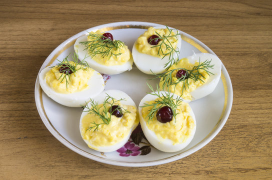 Stuffed egg with cranberry and green dill