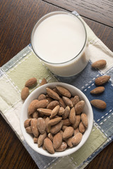 Almond Milk with almonds on table - Overhead