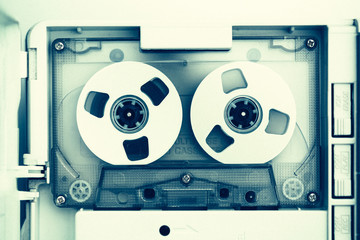 vintage audio tape compact cassette, green tone with artistic film noise