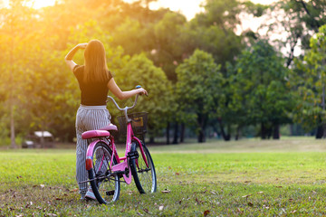 Young woman with bicycle in morning. healthy and lifestyle concept.