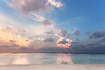 Beach on dusk, after sunset  with white sand and blue and white water © yaroslavasg