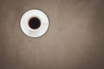 Top view of coffee cup on gray concrete background