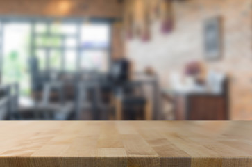 Selected focus empty brown wooden table and Coffee shop blur bac