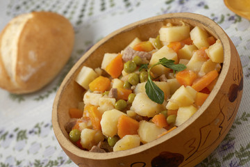 Tilted image of traditional peruvian meal Matasquita with bread in background