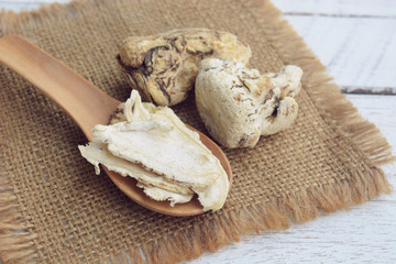 dang gui, angelica sinensis, dang gui ginseng on wooden background, traditional chinese herbal medicine.