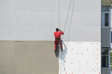 High worker hanging on the wall