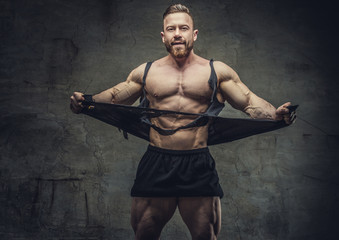 Fototapeta na wymiar Huge bodybuilder rend his garments.