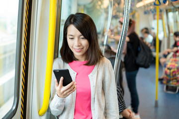 Woman use of mobile phone at train compartment