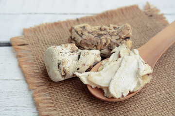 dang gui, angelica sinensis, dang gui ginseng on wooden background, traditional chinese herbal medicine.