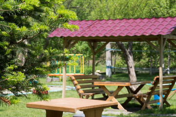 Wooden table and two benches with a canopy on the open air